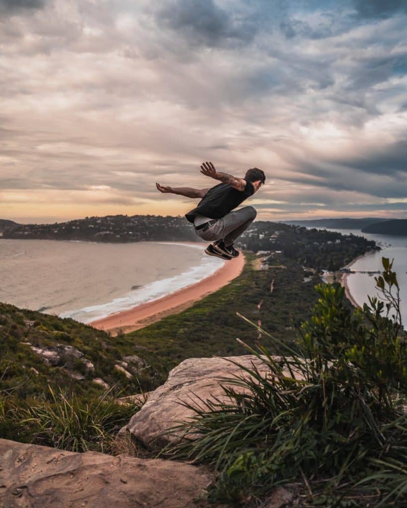 time lapse photography of man jumping from mountain cliff